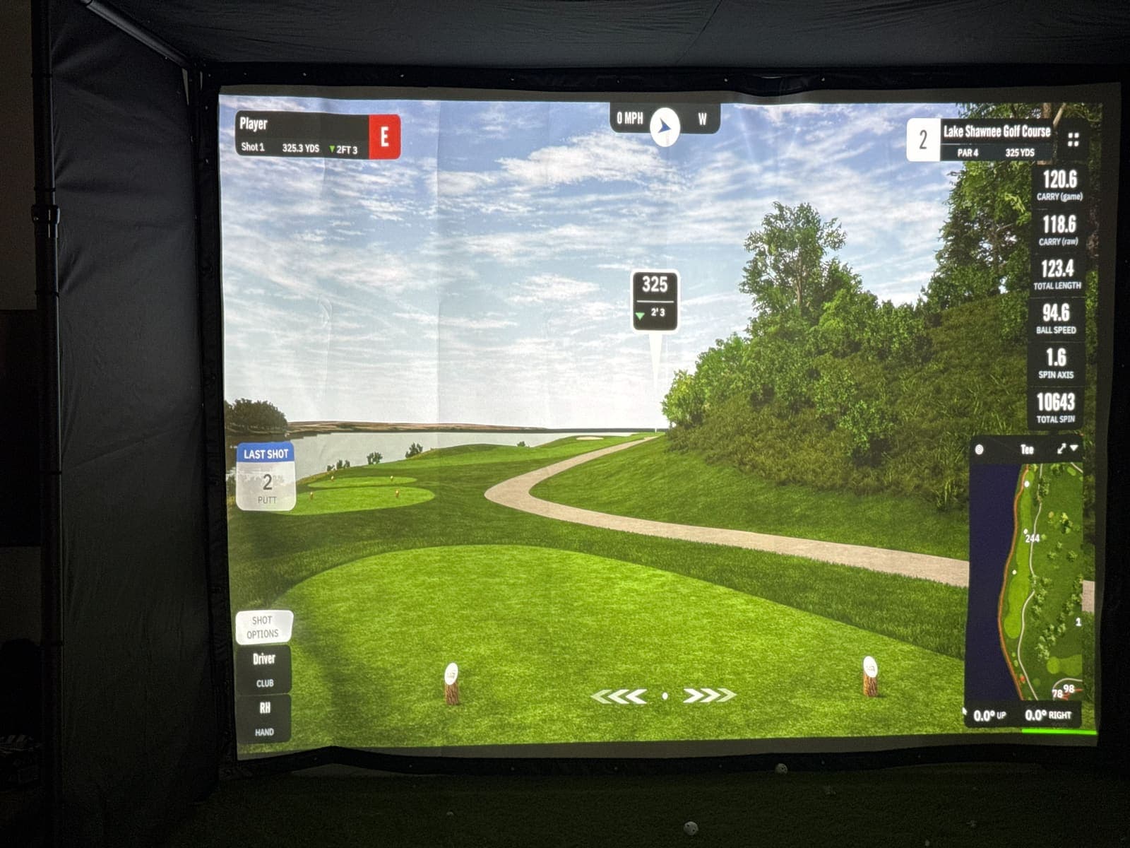 Close view of the GSPro course image on the impact screen inside the factory sample. Phone photo, October 11, 2026.